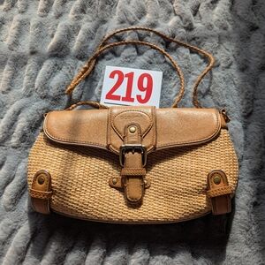Lot 219 BCBGirls woven clutch purse featuring tan leather trim and woven straw